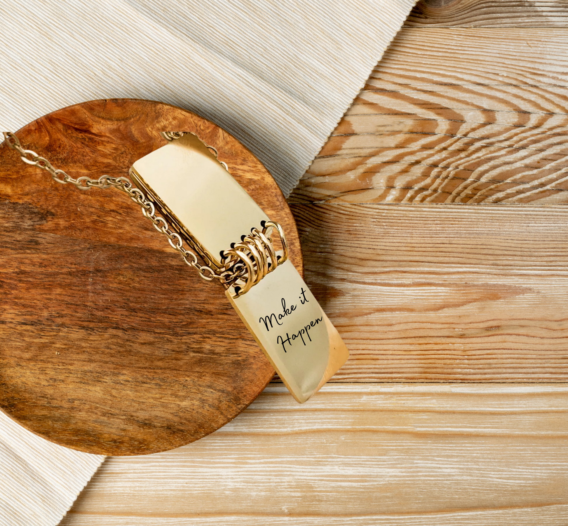 Close-up of engraved notebook pendant showing custom quote text